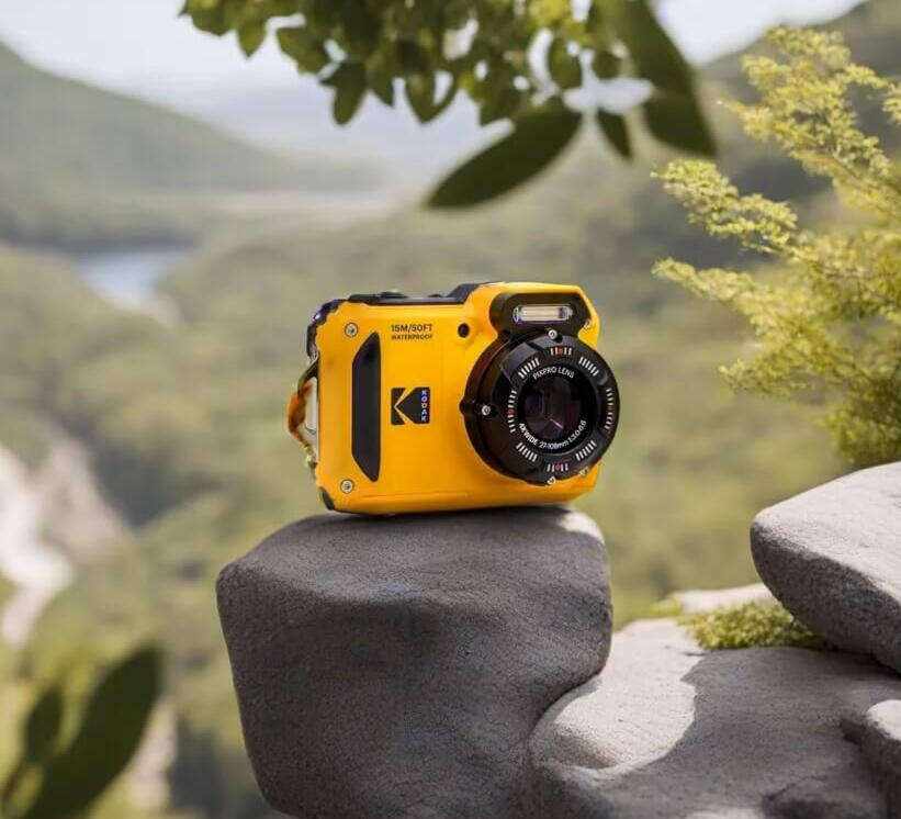 A yellow Kodak Pix Pro dive camera displayed on a rock.